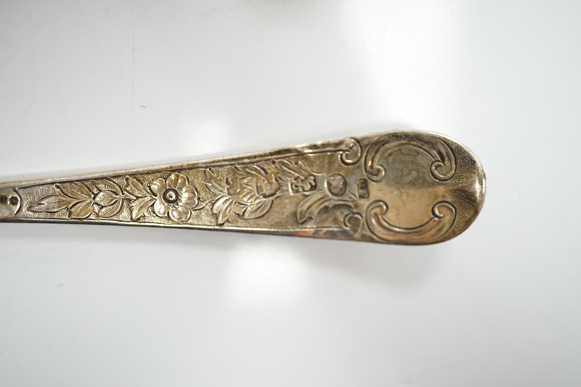 A group of assorted silver including a George III Irish silver basing spoon, Dublin, 1804, 29.5cm, a similar sauce ladle, two Georgian berry spoons, a late Victorian heart shaped photograph frame, a heart shaped pill box